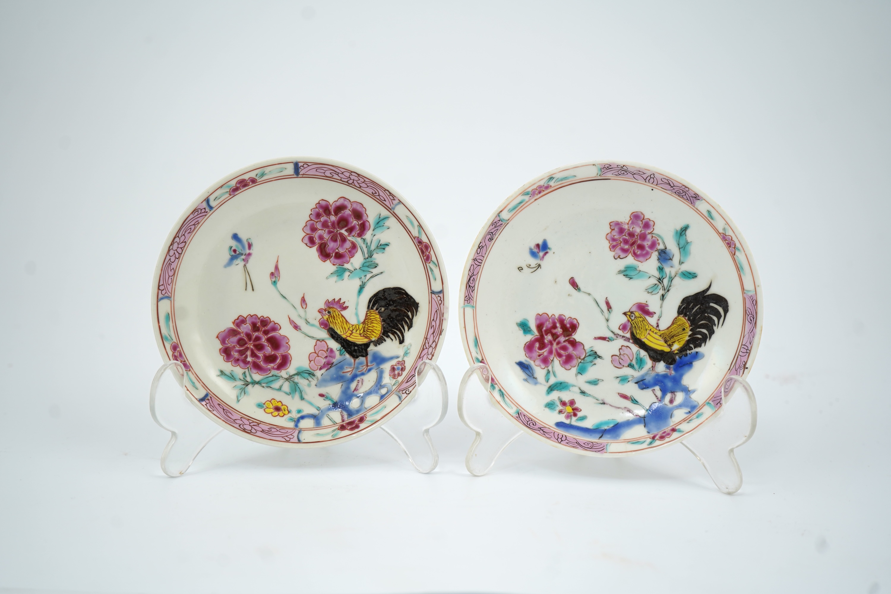 A near pair of Chinese famille rose ‘cockerel’ tea bowls and saucers, Yongzheng period